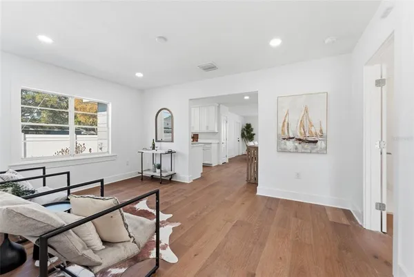 a living room with furniture and wooden floor