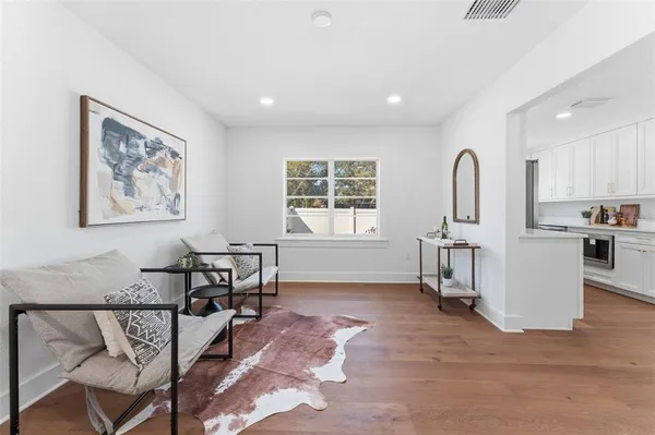 a living room with furniture a window and a table