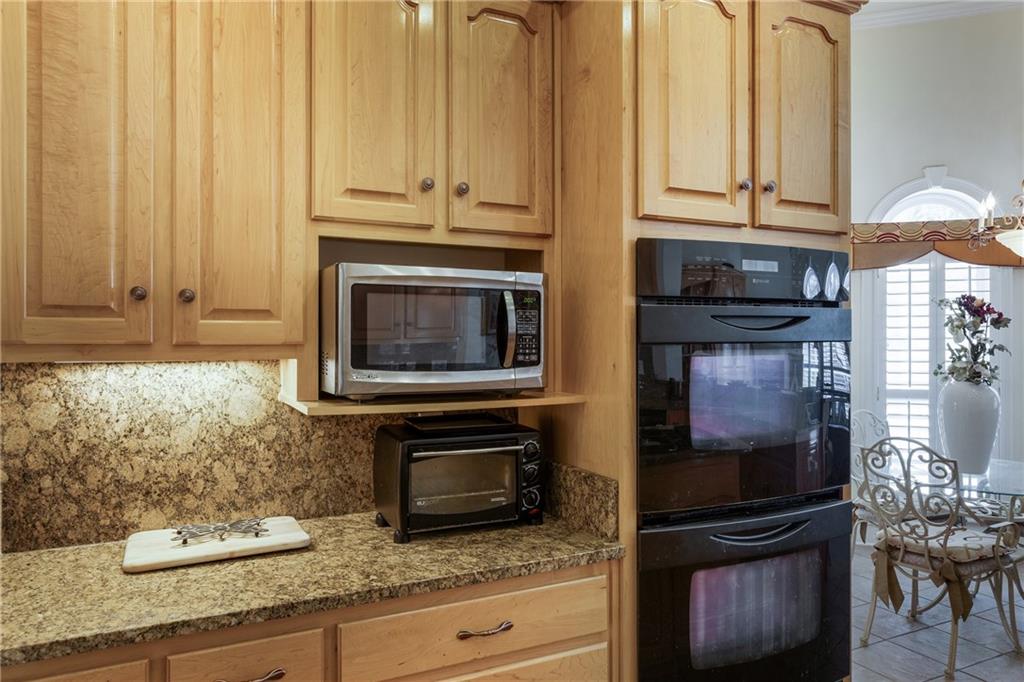7249 Confederate Lane Villa Rica, GA 30180 - Photo 16 of 49 a kitchen with granite countertop cabinets stainless steel appliances and a counter space