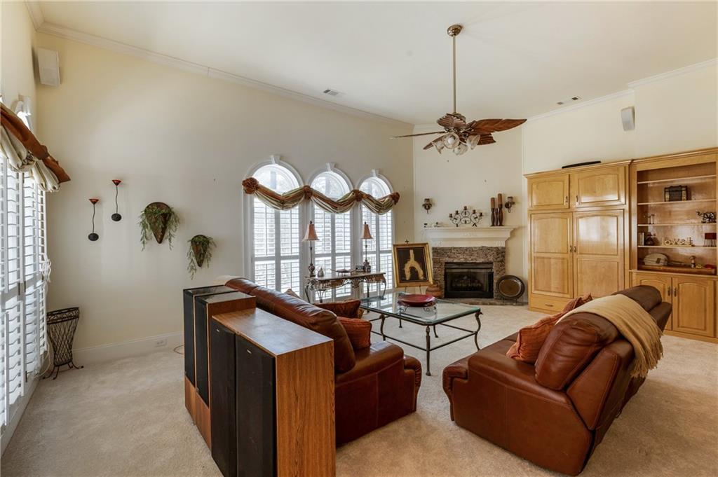 7249 Confederate Lane Villa Rica, GA 30180 - Photo 17 of 49 a living room with furniture a fireplace and a chandelier