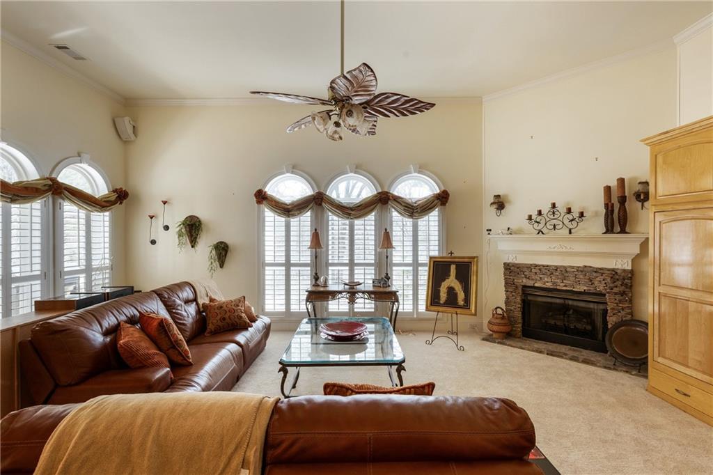 7249 Confederate Lane Villa Rica, GA 30180 - Photo 18 of 49 a living room with furniture a fireplace and a large mirror