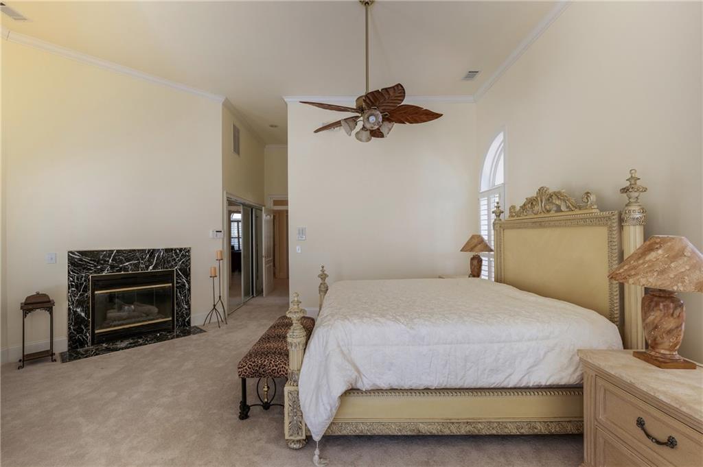 7249 Confederate Lane Villa Rica, GA 30180 - Photo 23 of 49 a bedroom with a bed dresser and a fireplace