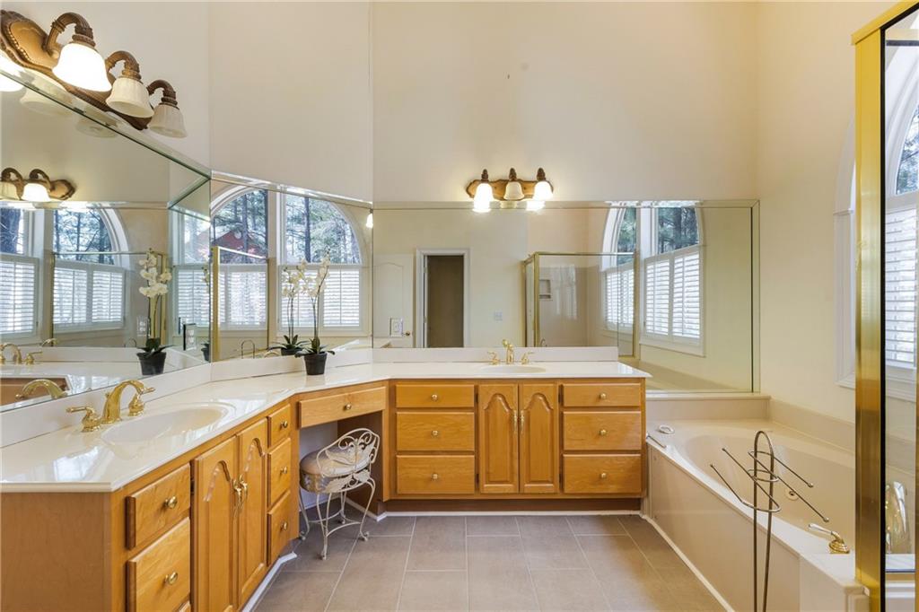 7249 Confederate Lane Villa Rica, GA 30180 - Photo 27 of 49 a spacious bathroom with a tub double sink and window