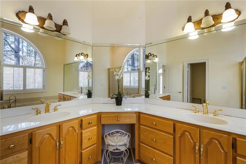 7249 Confederate Lane Villa Rica, GA 30180 - Photo 28 of 49 a bathroom with a granite countertop sink a mirror and a bathtub