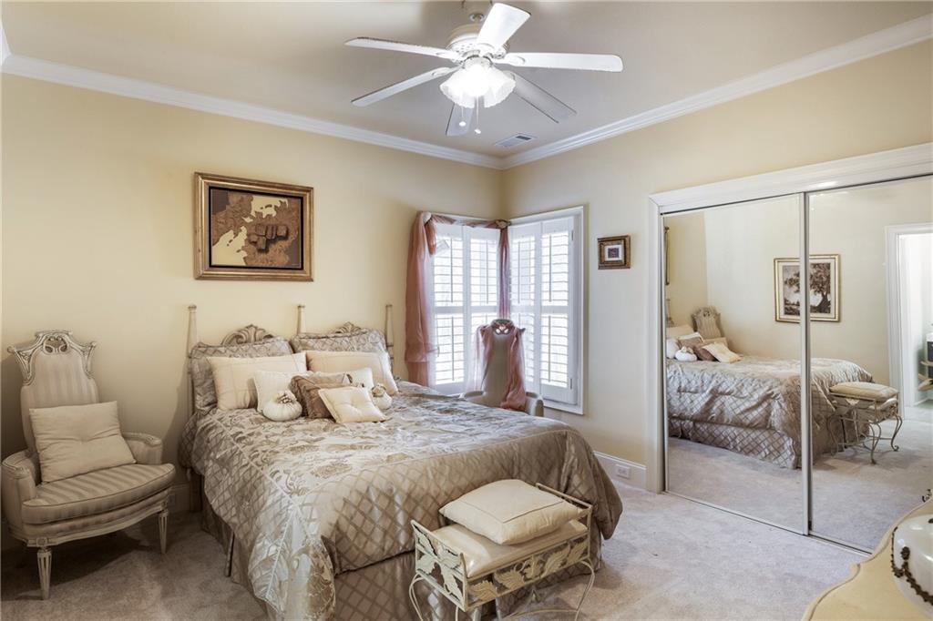 7249 Confederate Lane Villa Rica, GA 30180 - Photo 35 of 49 a bedroom with a bed and a chandelier
