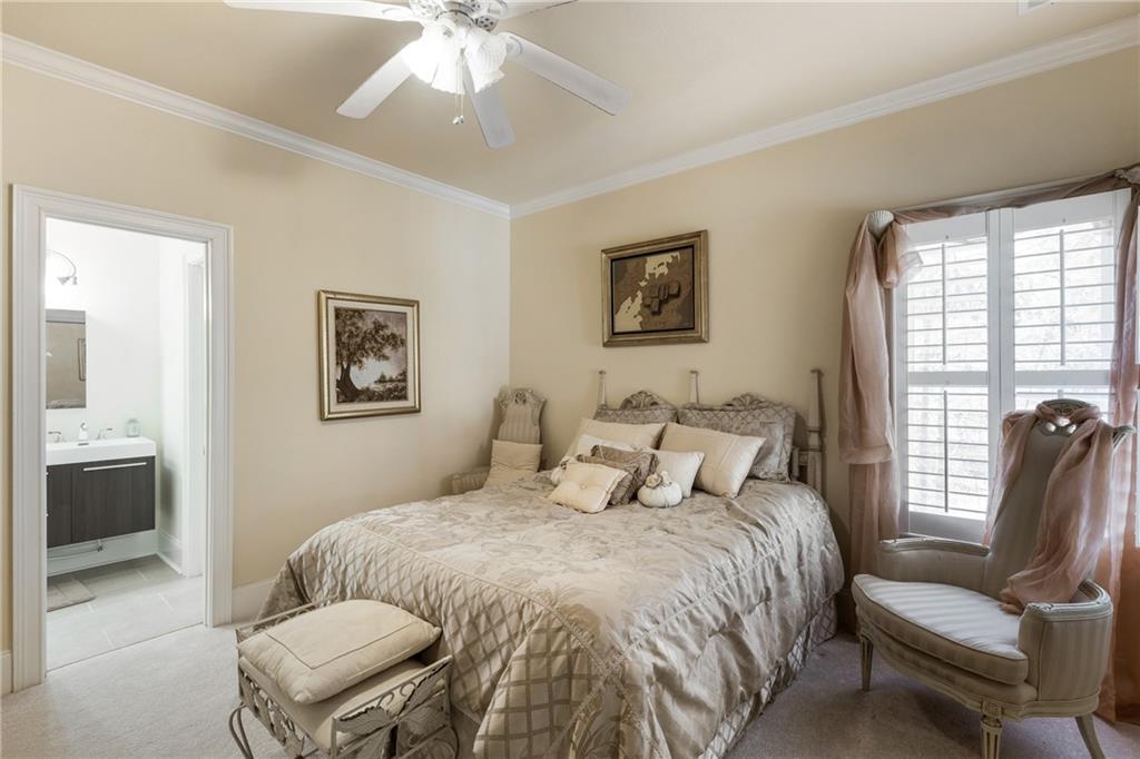 7249 Confederate Lane Villa Rica, GA 30180 - Photo 37 of 49 a bedroom with a bed and a chandelier