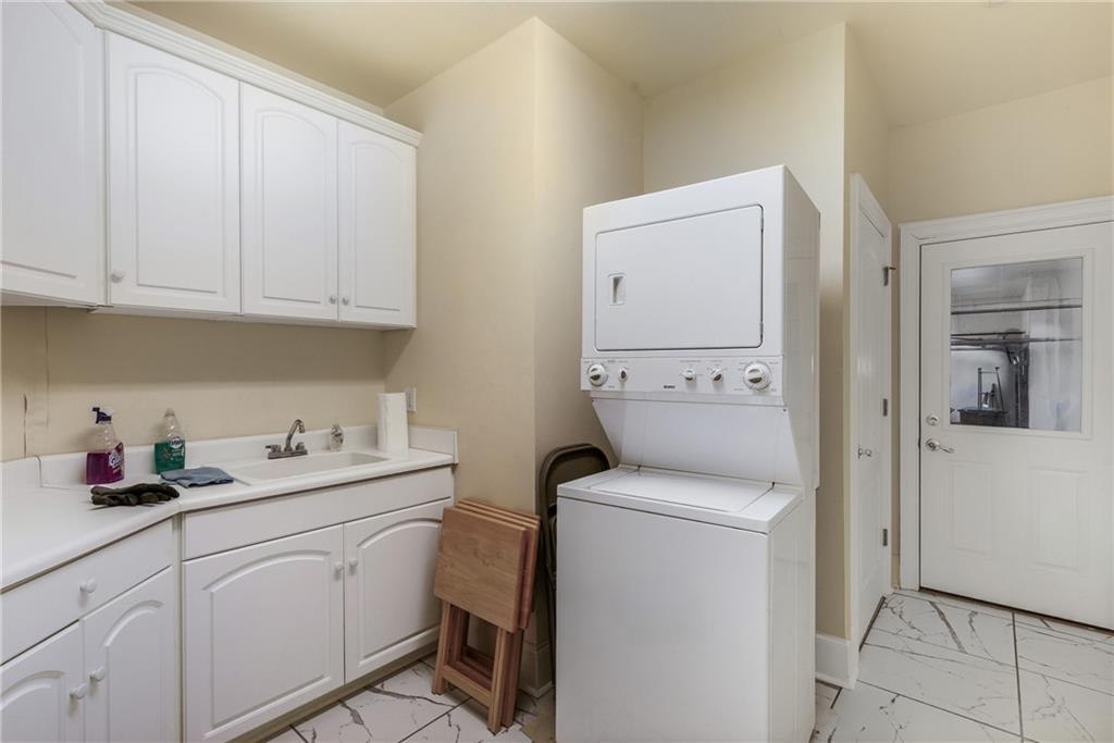 7249 Confederate Lane Villa Rica, GA 30180 - Photo 40 of 49 a utility room with sink dryer and washer