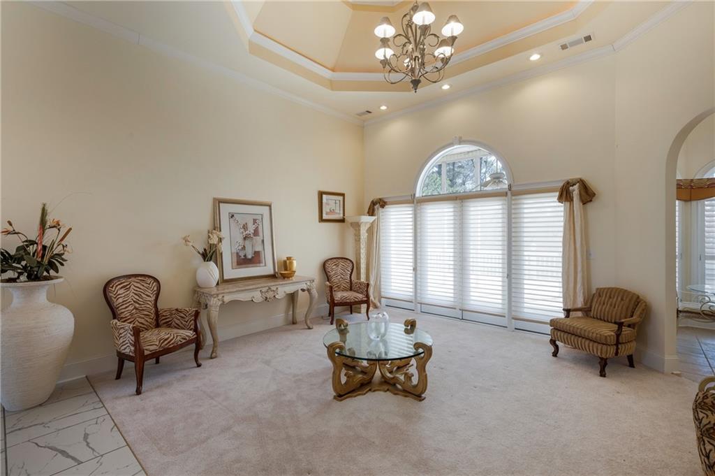 7249 Confederate Lane Villa Rica, GA 30180 - Photo 6 of 49 a living room with furniture and a chandelier