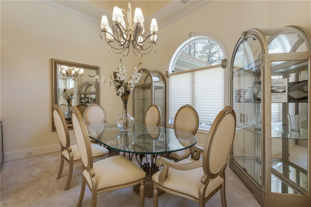 7249 Confederate Lane Villa Rica, GA 30180 - Photo 8 of 49 a view of a dining room with furniture a chandelier and wooden floor