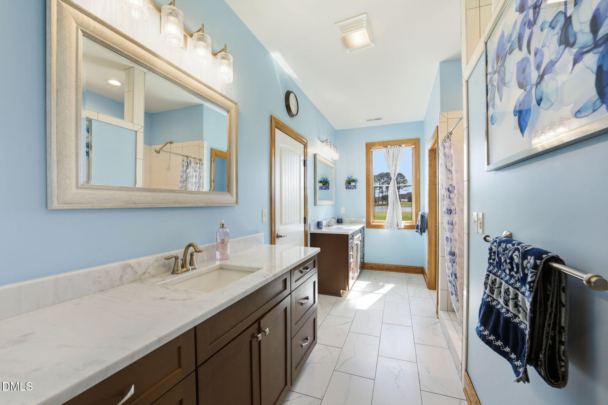 35 North Rippling Court Smithfield, NC 27577 - Photo 26 of 59 a spacious bathroom with a double vanity sink a mirror and a shower