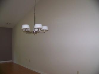 2740 Upstream Farm Road Easton, PA 18040 - Photo 13 of 13 A sleek, contemporary chandelier illuminates the open-concept living space, highlighting its soaring vaulted ceiling.