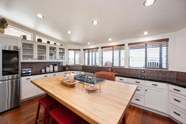 a living room with granite countertop furniture and a flat screen tv