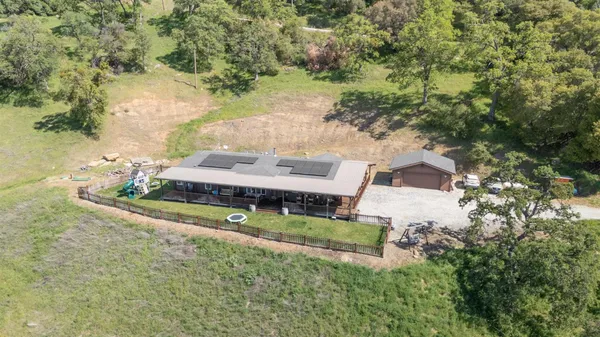an aerial view of a house with a yard basket ball court and outdoor seating