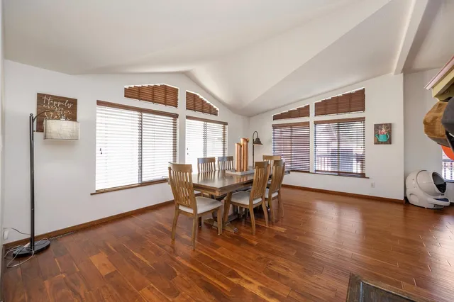 a view of a dining room with furniture and wooden floor