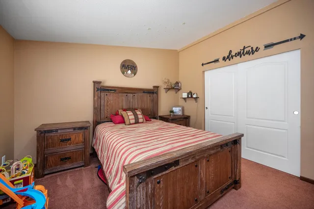 a bedroom with a bed and a dresser