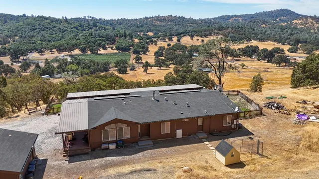 an aerial view of a house with a yard