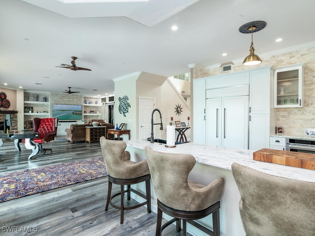 16410 Oakview Circle Alva, FL 33920 - Photo 11 of 39 a living room with furniture kitchen view and a chandelier