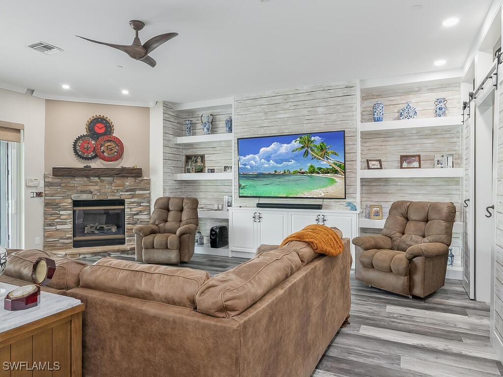 16410 Oakview Circle Alva, FL 33920 - Photo 12 of 39 a living room with furniture a flat screen tv and a fireplace