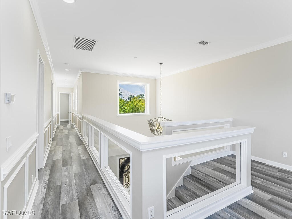 16410 Oakview Circle Alva, FL 33920 - Photo 19 of 39 a view of a hallway with wooden floor and staircase