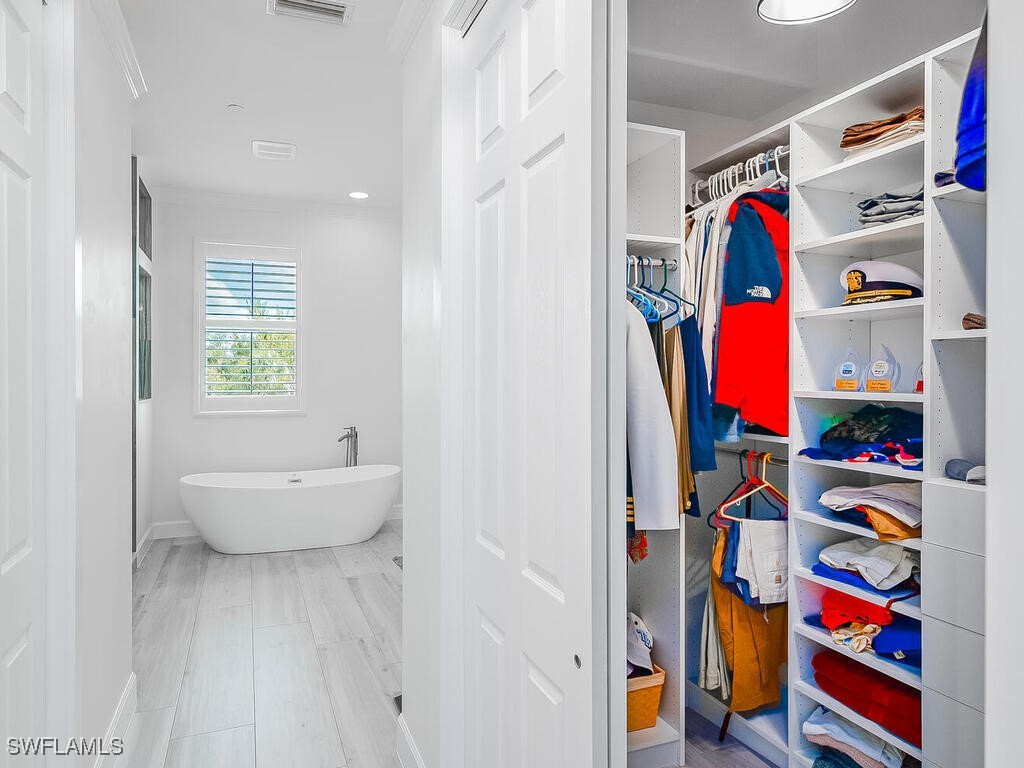 16410 Oakview Circle Alva, FL 33920 - Photo 21 of 39 a view of walk in closet with clothes and shoes