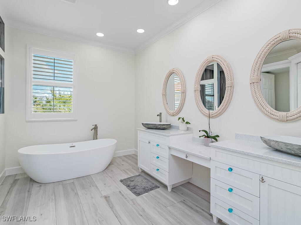 16410 Oakview Circle Alva, FL 33920 - Photo 22 of 39 a spacious bathroom with a double vanity sink mirror and bathtub