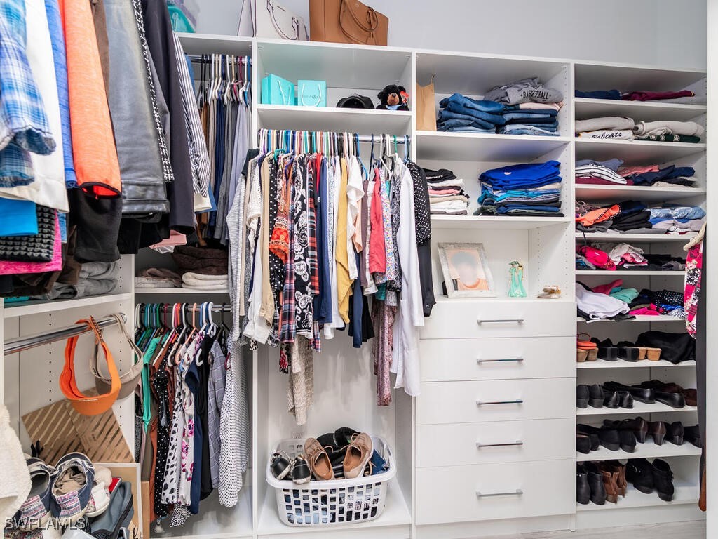 16410 Oakview Circle Alva, FL 33920 - Photo 24 of 39 a view of walk in closet with clothes and shoes