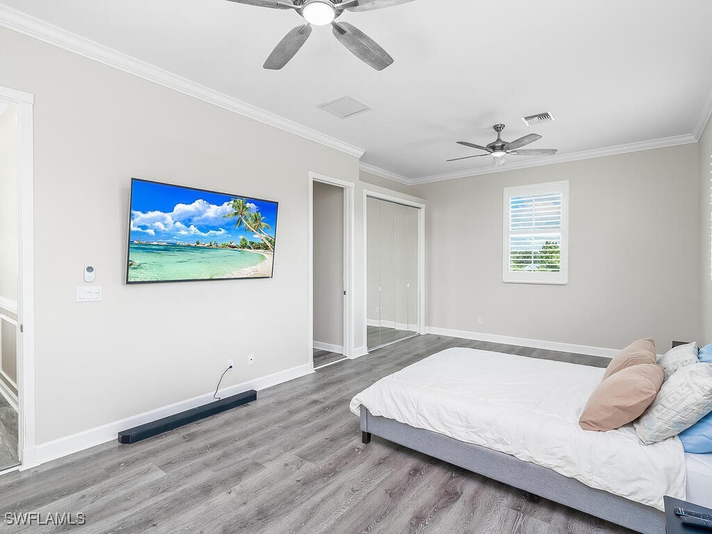 16410 Oakview Circle Alva, FL 33920 - Photo 29 of 39 a bedroom with a large bed and a chandelier