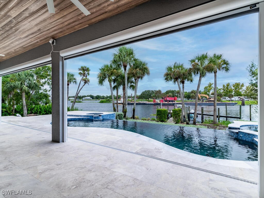 16410 Oakview Circle Alva, FL 33920 - Photo 32 of 39 a view of a porch with a floor to ceiling window and potted plants