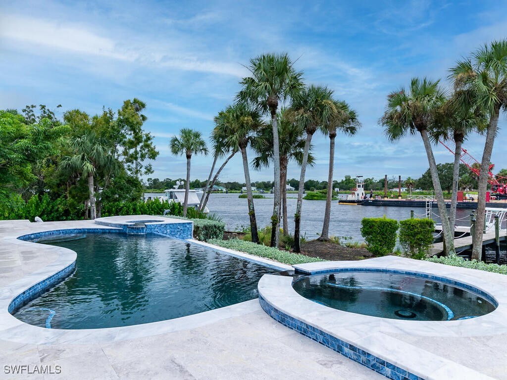 16410 Oakview Circle Alva, FL 33920 - Photo 33 of 39 a view of a swimming pool with a garden