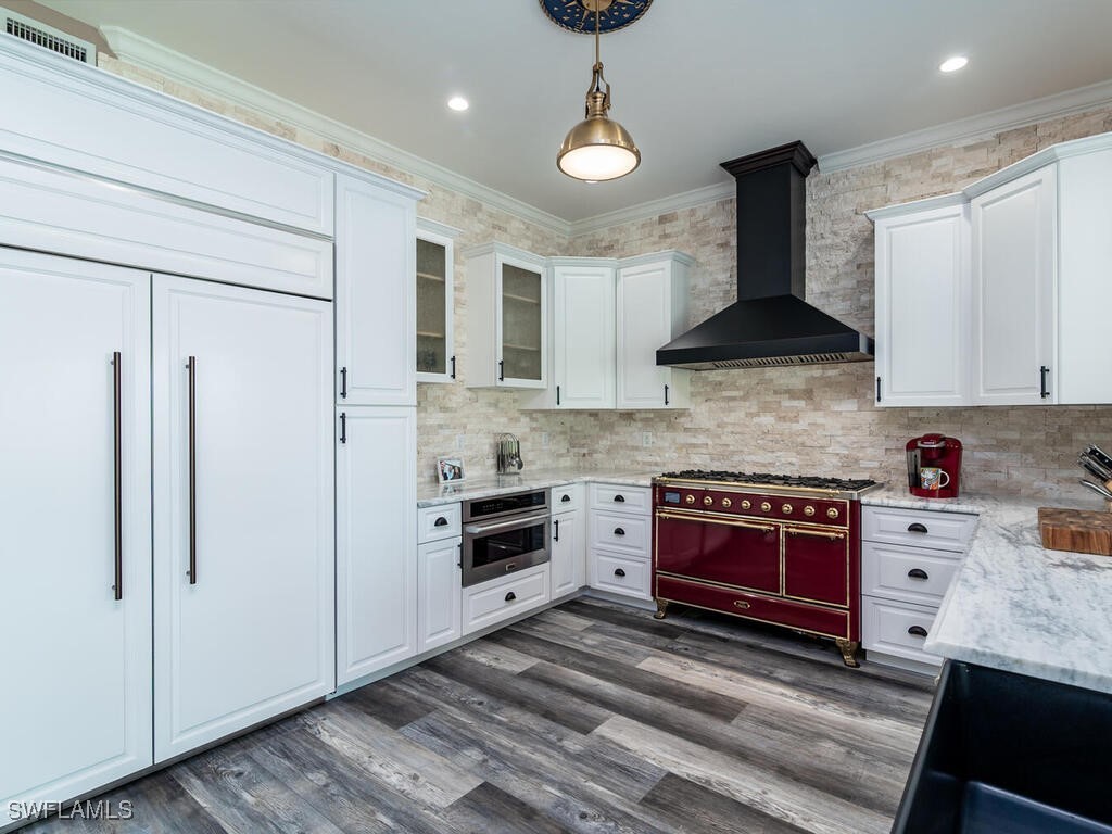 16410 Oakview Circle Alva, FL 33920 - Photo 8 of 39 a kitchen with stainless steel appliances a stove a refrigerator a sink and white cabinets