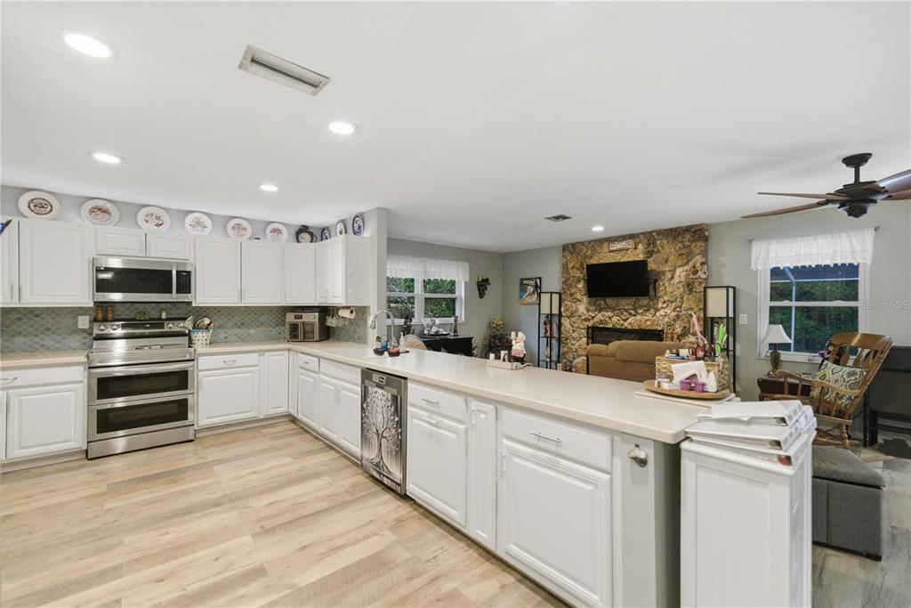 8951 Southwest 202nd Avenue Road Dunnellon, FL 34431 - Photo 11 of 38 a kitchen with appliances a sink and cabinets