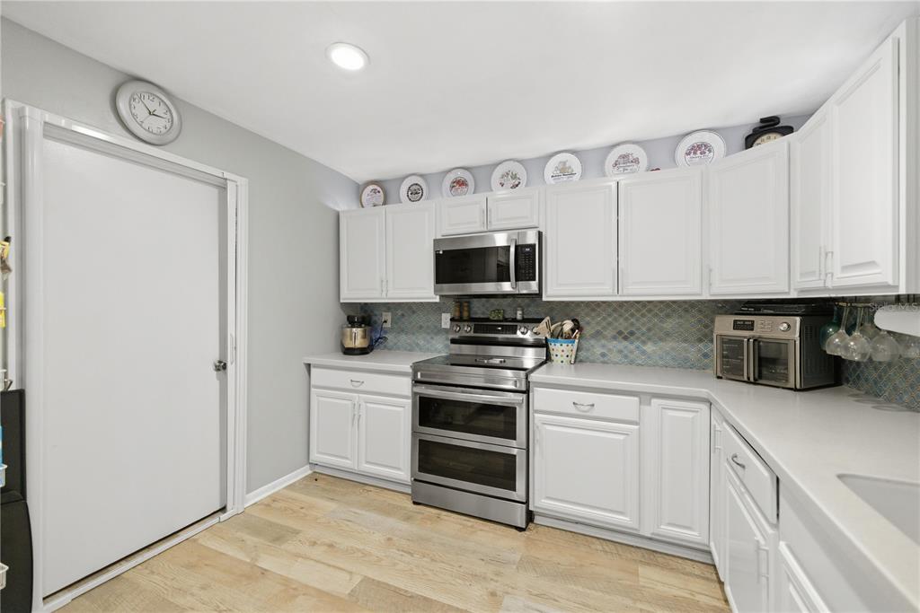 8951 Southwest 202nd Avenue Road Dunnellon, FL 34431 - Photo 12 of 38 a kitchen with stainless steel appliances granite countertop a stove and a sink