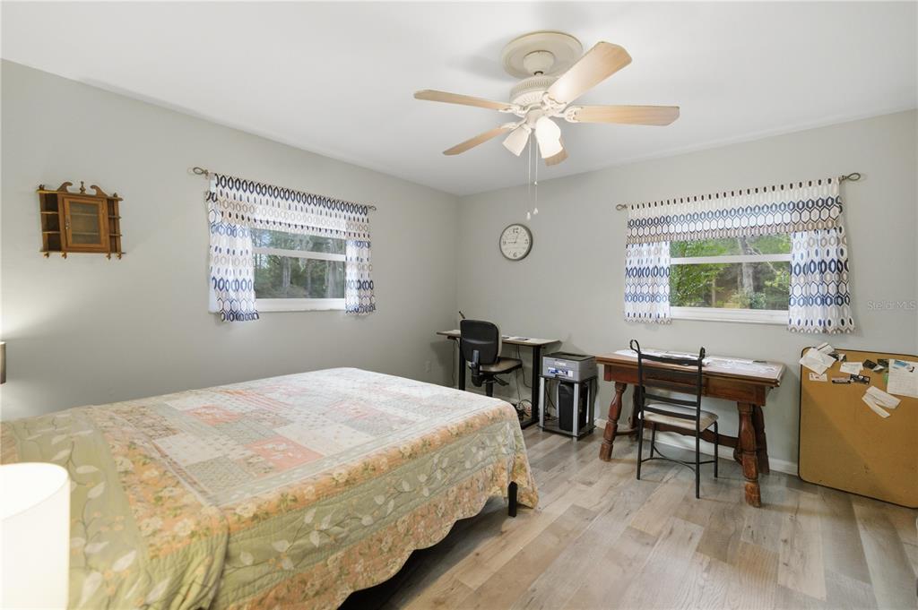 8951 Southwest 202nd Avenue Road Dunnellon, FL 34431 - Photo 19 of 38 a bedroom with a bed and a table chair