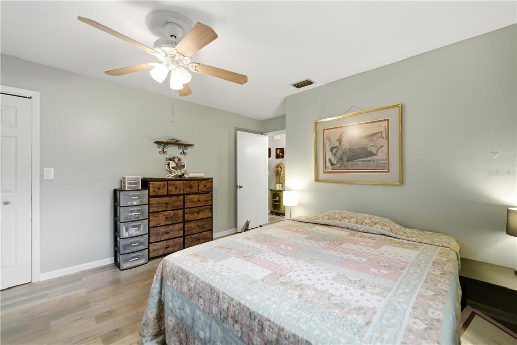 8951 Southwest 202nd Avenue Road Dunnellon, FL 34431 - Photo 20 of 38 a bedroom with a bed and a chandelier