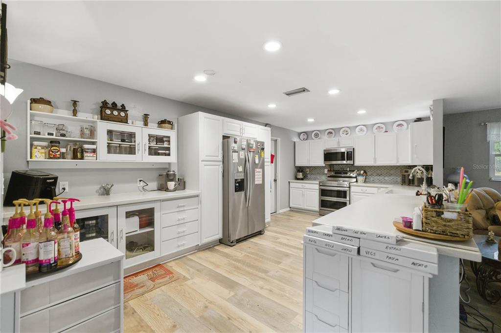 8951 Southwest 202nd Avenue Road Dunnellon, FL 34431 - Photo 3 of 38 a kitchen with a refrigerator and cabinets