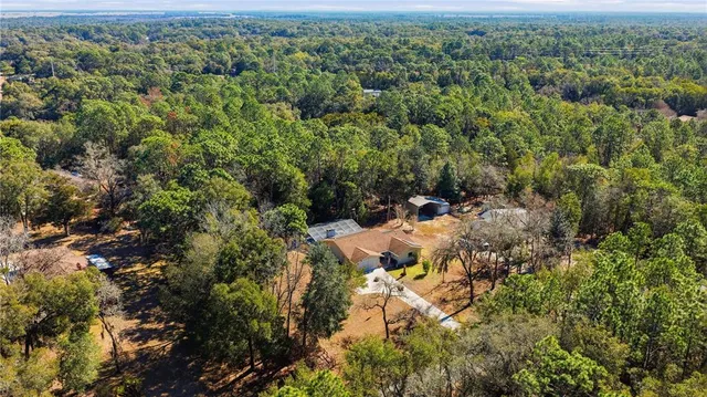 an aerial view of a houses with a yard