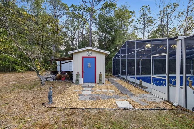 a view of a chair and table in the back yard