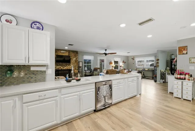 a kitchen with sink cabinets and wooden floor