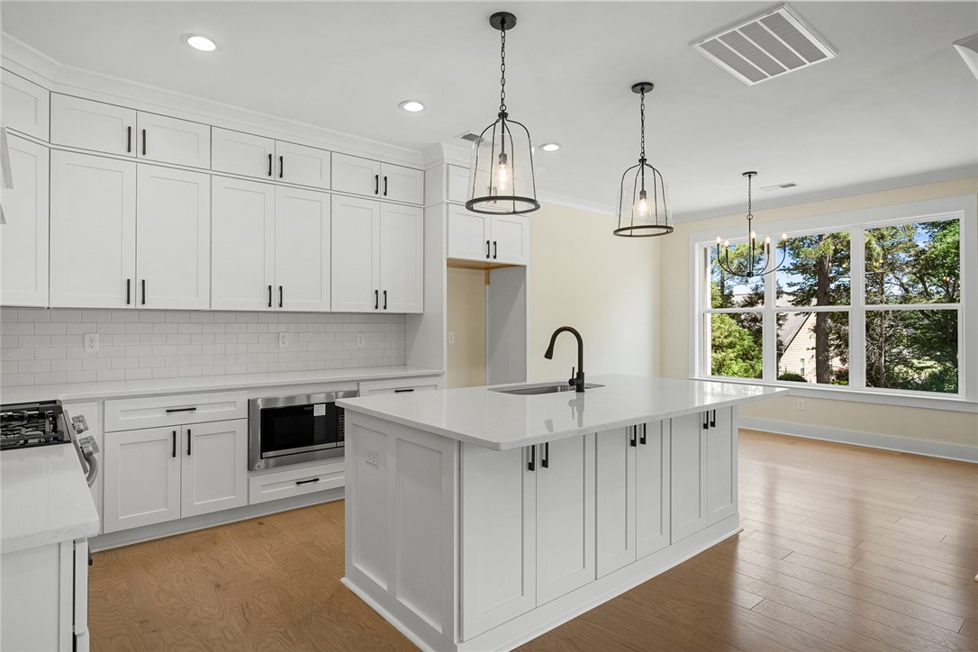 100 Garden Gate Drive Anderson, SC 29621 - Photo 13 of 43 This bright kitchen features an island, ample cabinetry, and large windows with abundant light.
