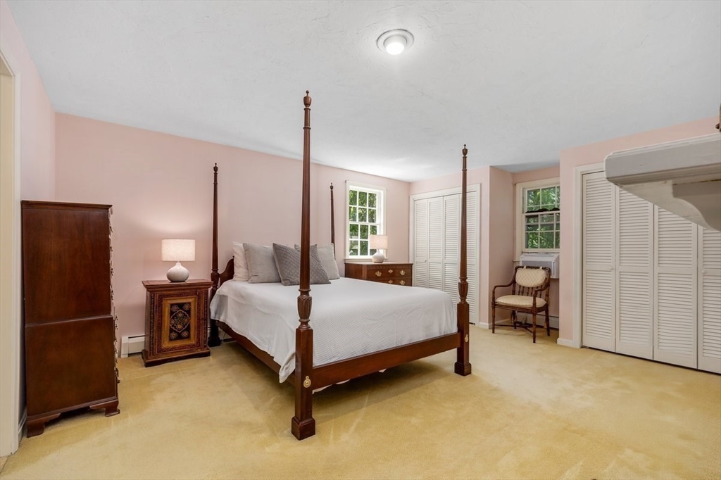 445 Cushing Street Hingham, MA 02043 - Photo 13 of 29 a bed room with a bed and a chair