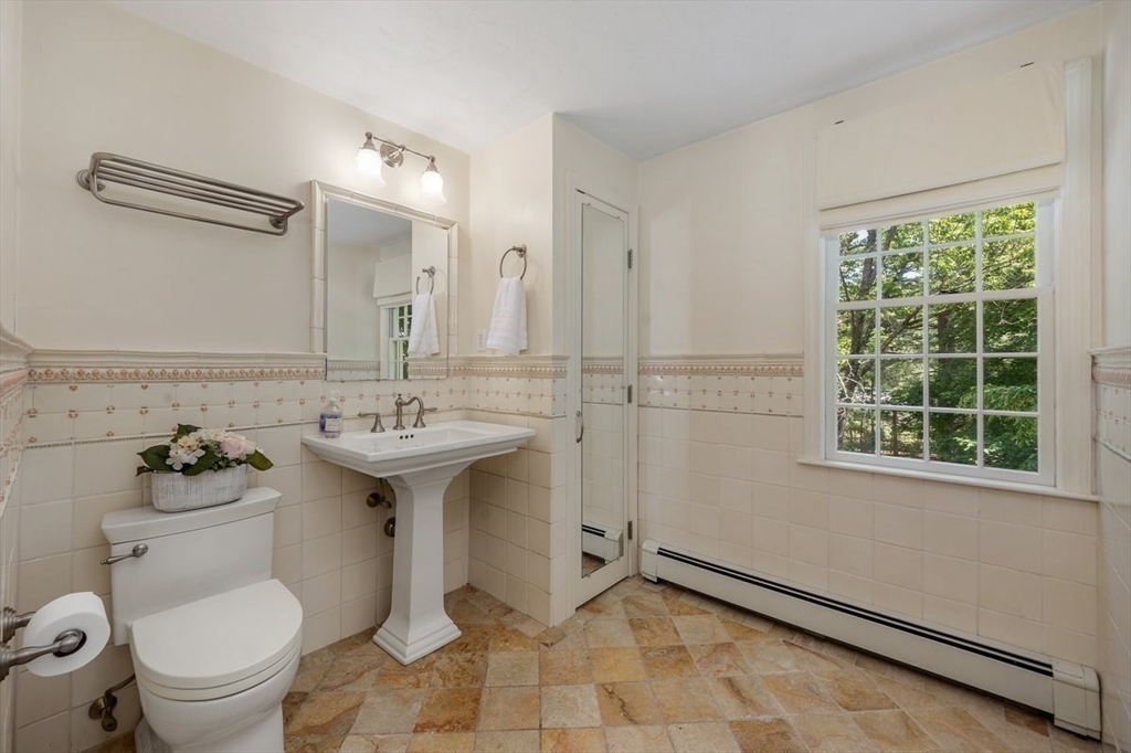 445 Cushing Street Hingham, MA 02043 - Photo 16 of 29 a bathroom with a sink toilet and a mirror