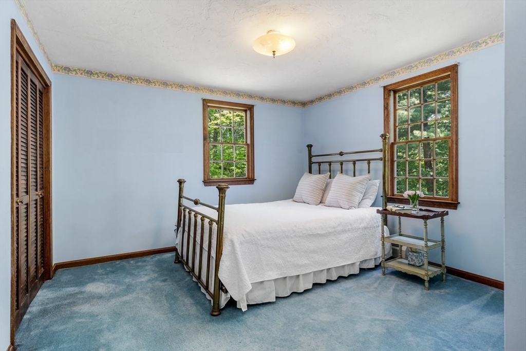 445 Cushing Street Hingham, MA 02043 - Photo 20 of 29 a spacious bedroom with a bed and a window