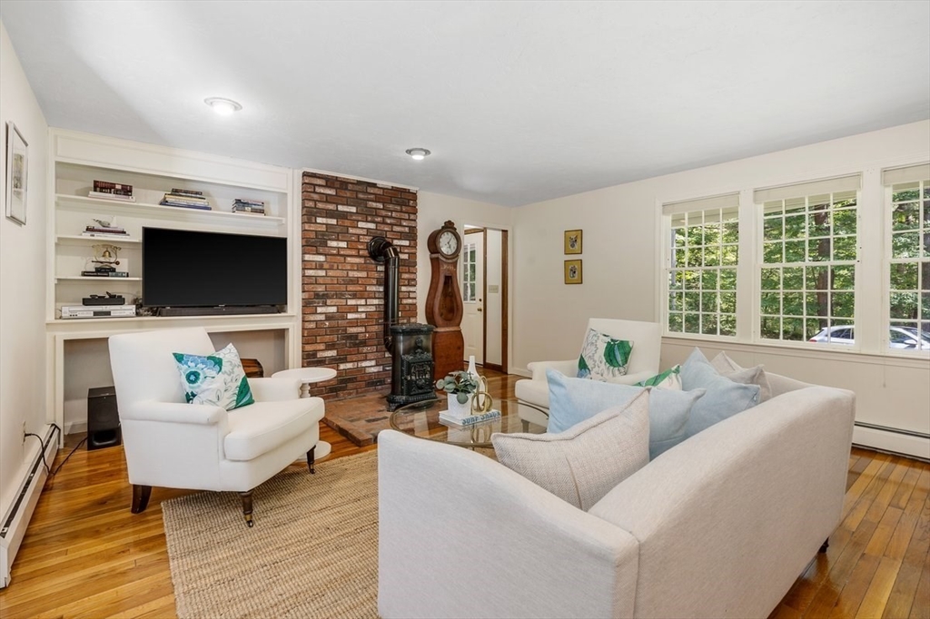 445 Cushing Street Hingham, MA 02043 - Photo 2 of 29 a living room with furniture and a flat screen tv