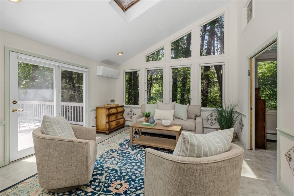 445 Cushing Street Hingham, MA 02043 - Photo 22 of 29 a living room with furniture large windows and wooden floor