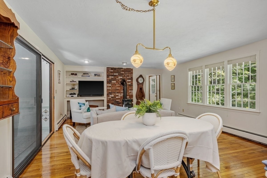 445 Cushing Street Hingham, MA 02043 - Photo 6 of 29 a view of a dining room with furniture a chandelier and wooden floor