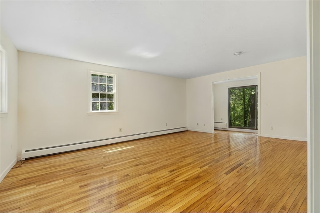 445 Cushing Street Hingham, MA 02043 - Photo 9 of 29 a view of an empty room with wooden floor and a window