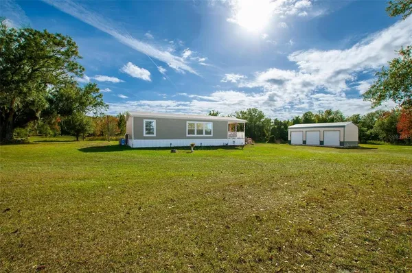 a front view of house with yard green space