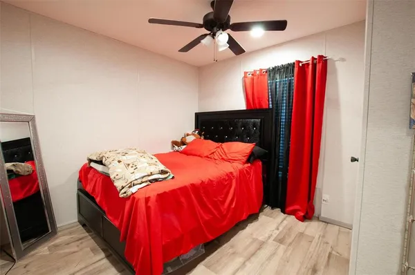 a bed sitting in a bedroom next to a window