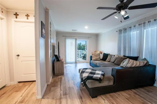 a living room with furniture and a wooden floor