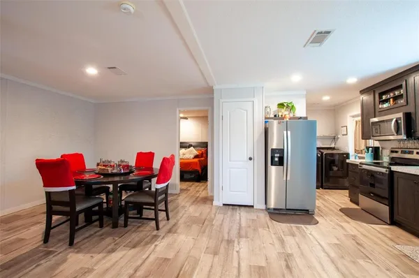 a view of a dining room with furniture and wooden floor
